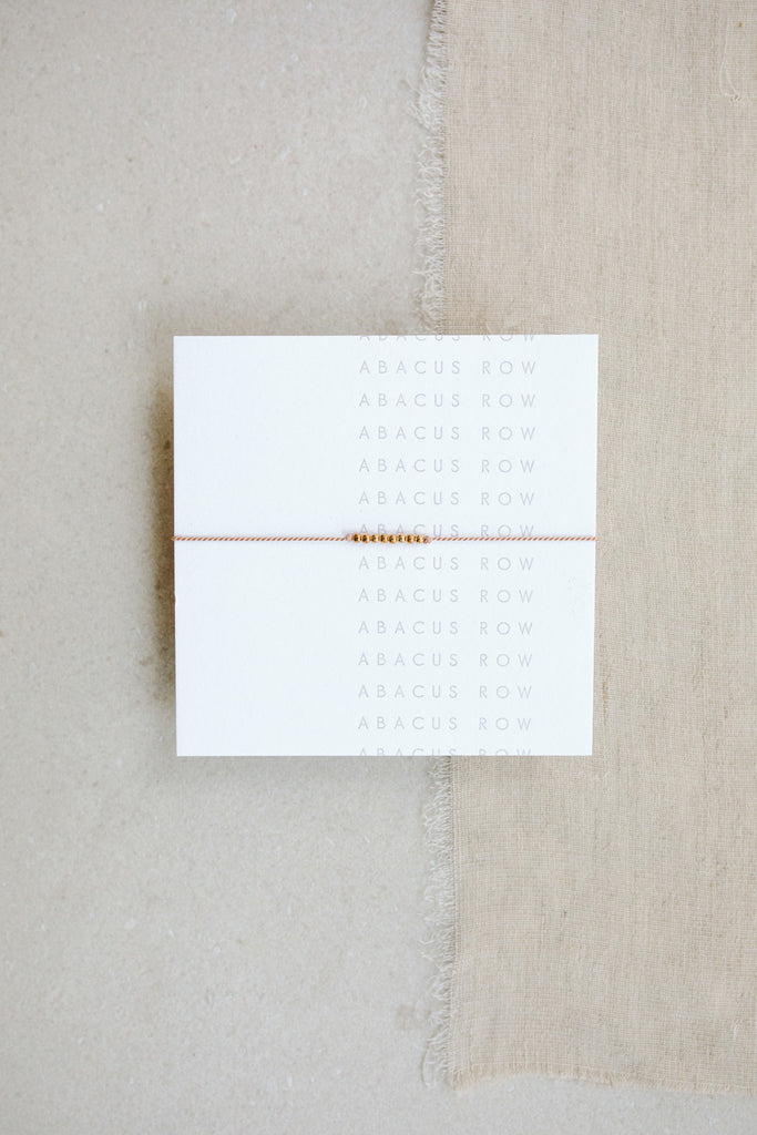 Friendship Bracelet No.3 in Blush pink on card by Abacus Row Handmade Jewelry