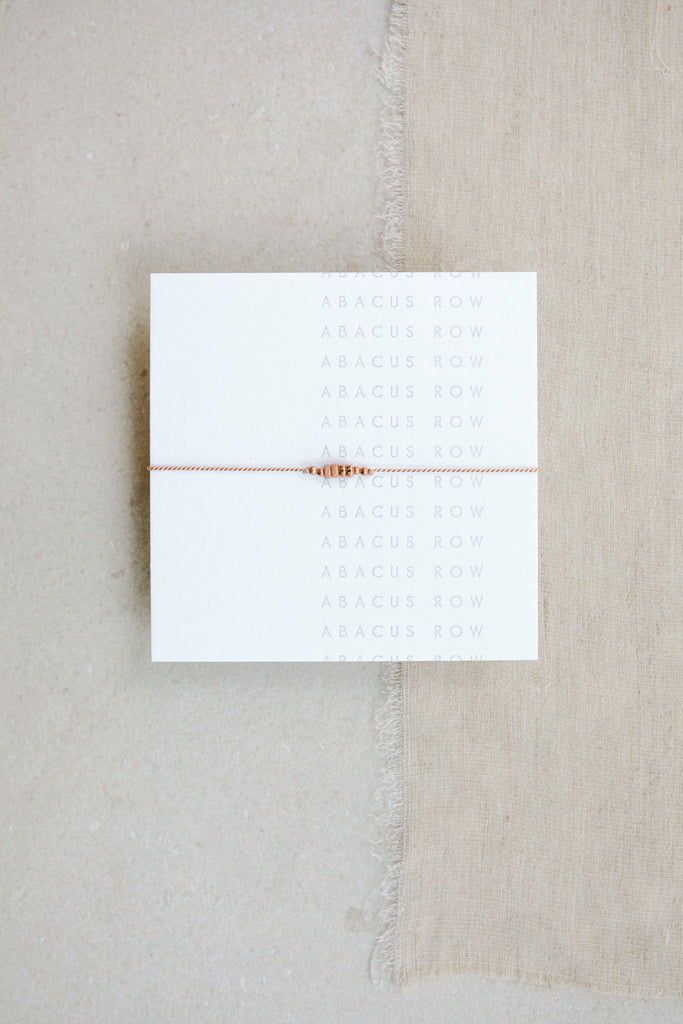 Friendship Bracelet No.5 in Blush pink on card by Abacus Row Handmade Jewelry