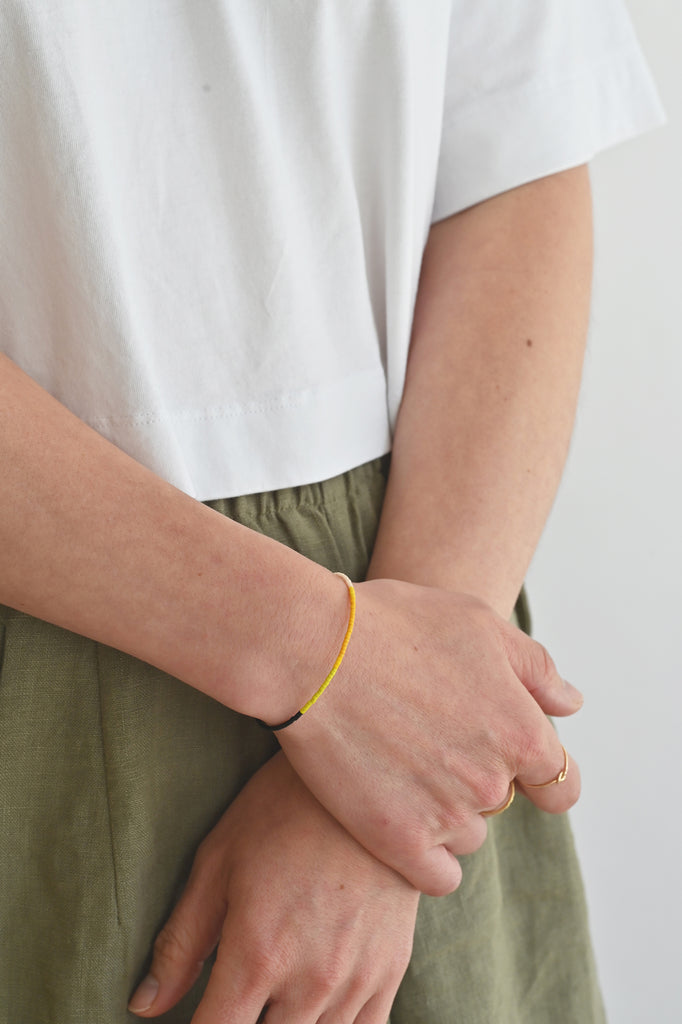 A Yellow Sun Bracelet styled on model at Abacus Row Handmade Jewelry