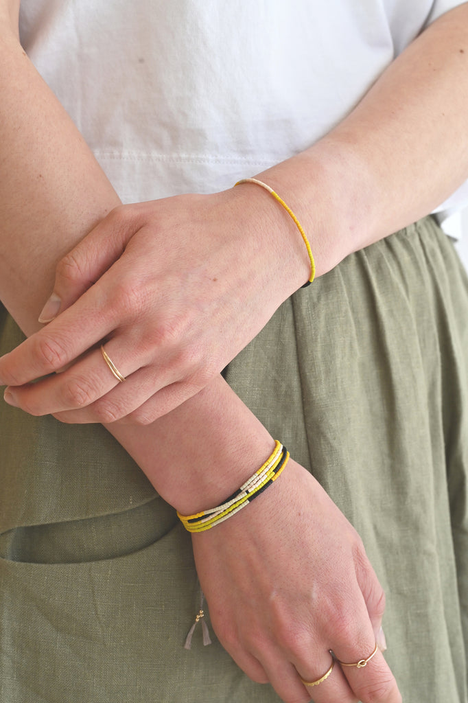 A Yellow Sun Bracelet and wrap styled on wrist at Abacus Row Handmade Jewelry