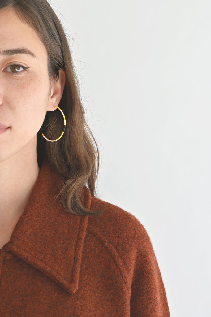 A Yellow Sun Large Hoop Earrings styled on model at Abacus Row Handmade Jewelry