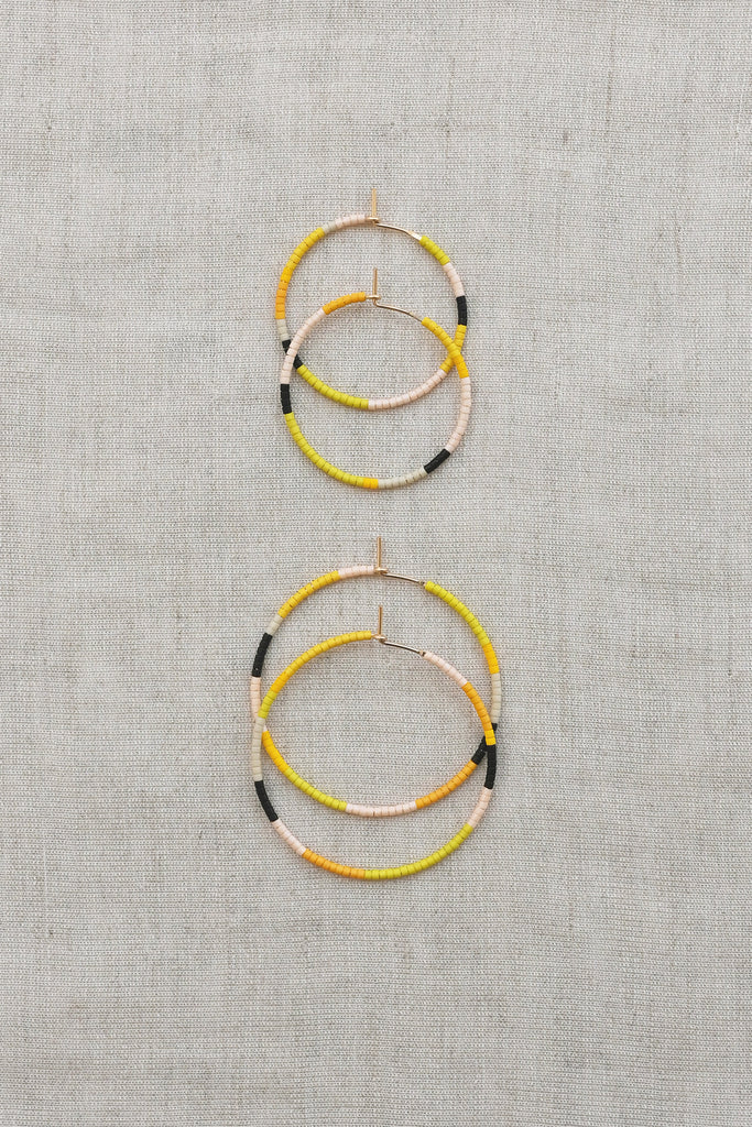A Yellow Sun Hoop Earrings styled at Abacus Row Handmade Jewelry