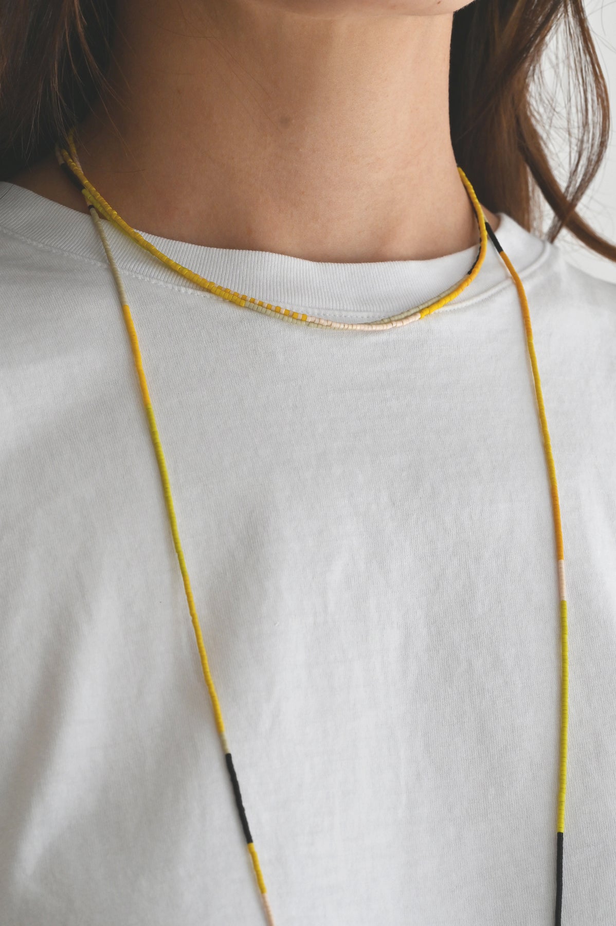 A Yellow Sun Necklace and wrap on model at Abacus Row Handmade Jewelry