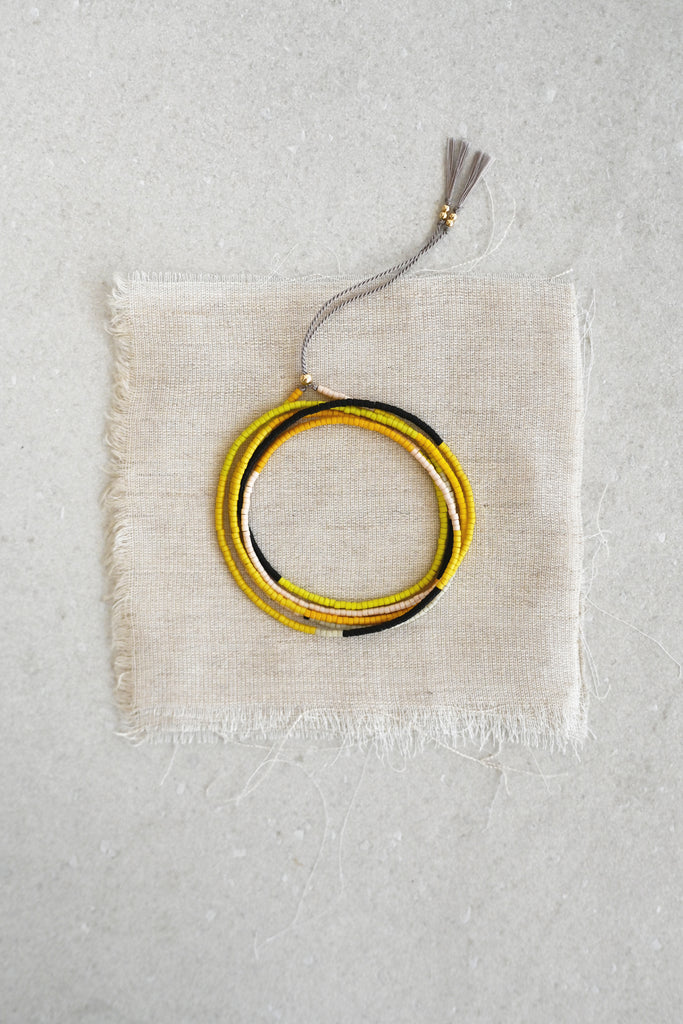 A Yellow Sun Wrap styled at Abacus Row Handmade Jewelry