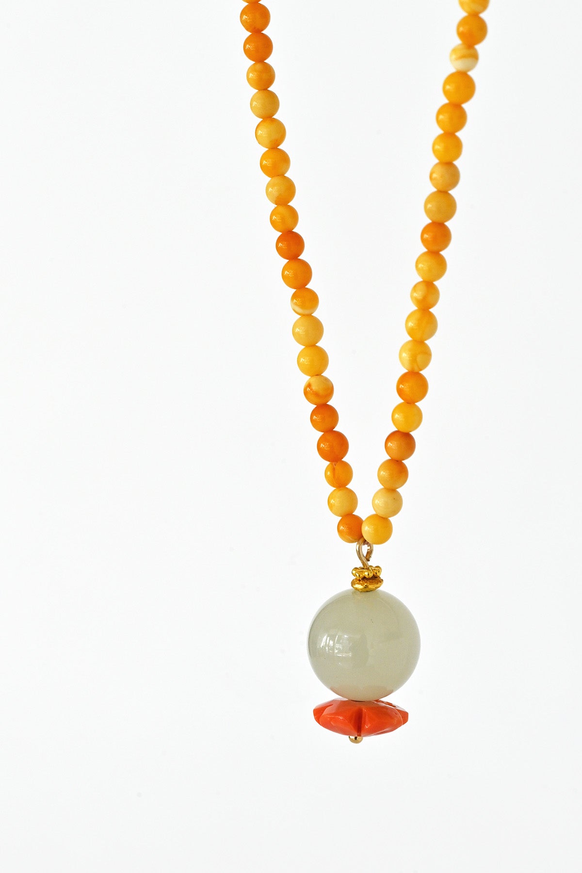 Detail of Mai Beaded Amber Necklace with Jade Coral Pendant at Abacus Row Jewelry