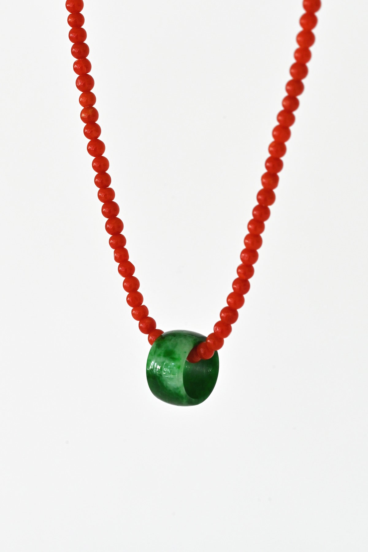 Close up of the Beaded Coral Necklace with Jade Pendant at Abacus Row Handmade Jewelry