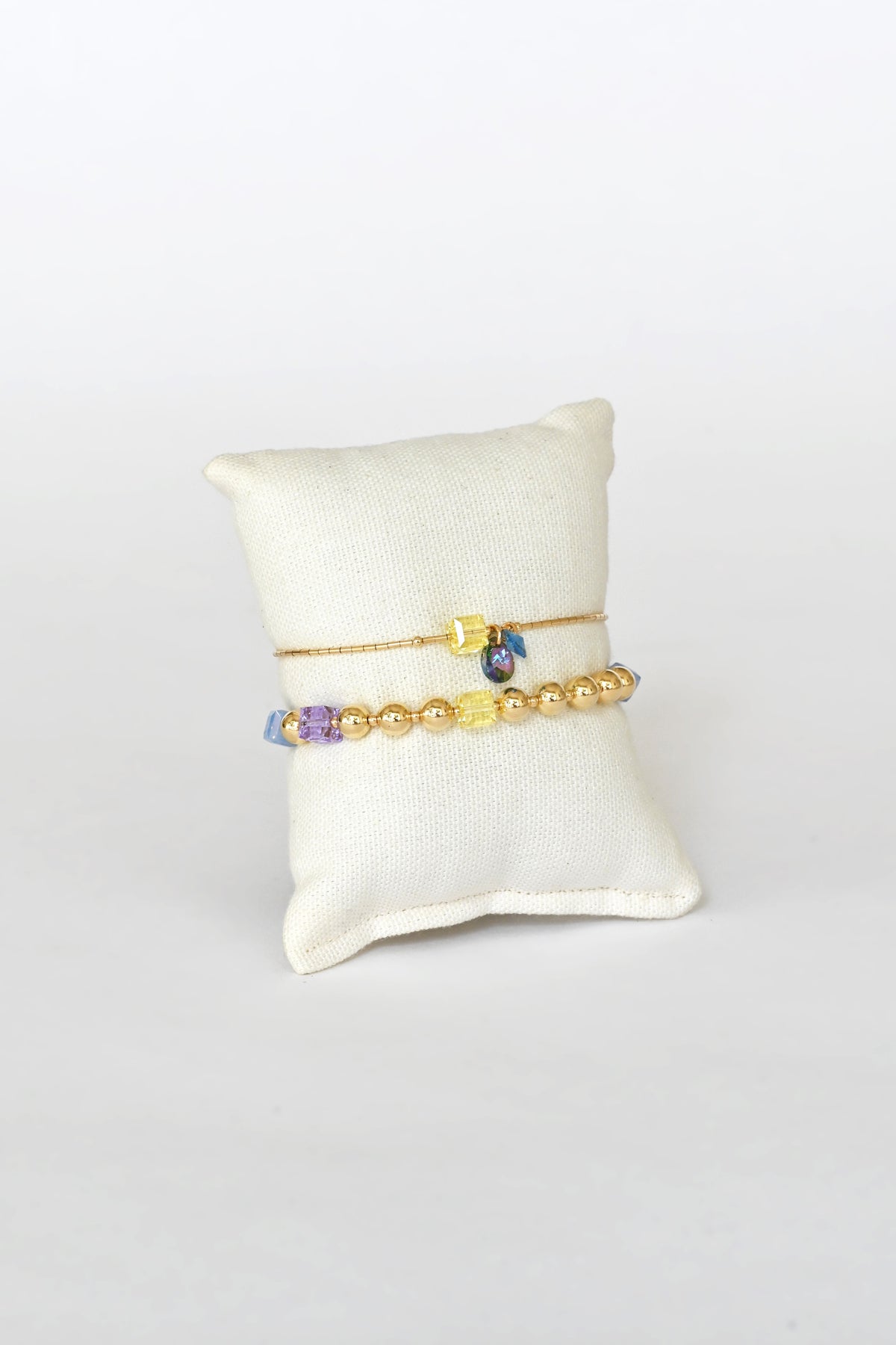 Daisy Chain Bracelet No.2 with Linaria Garden Collection front view on pillow at Abacus Row Jewelry