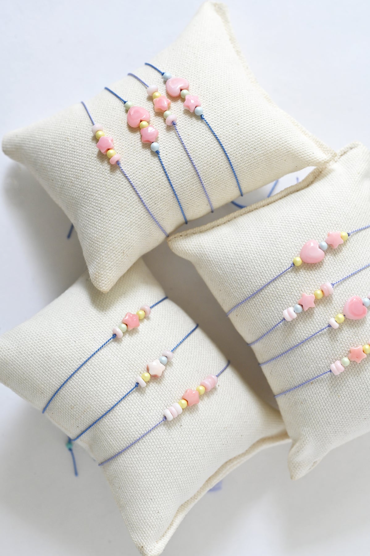 Dream Cloud Assorted Wishing Charms Bracelets on Pillows by Abacus Row Handmade Jewelry