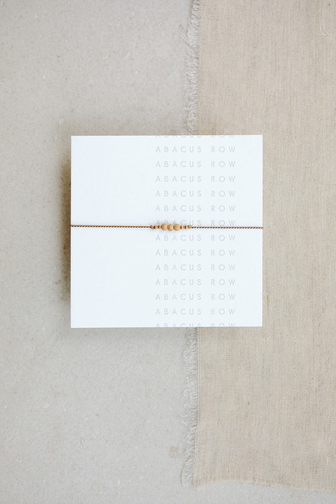 Friendship Bracelet No.1 in beige Fawn on a card by Abacus Row Handmade Jewelry