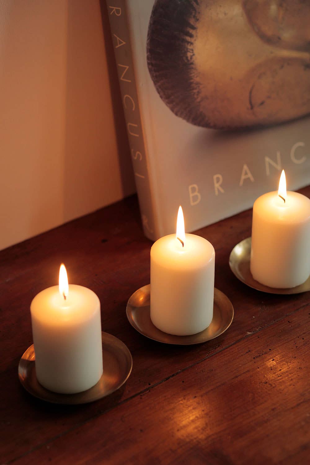 Small Round Brass Trays by Fog Linen with candles at Abacus Row