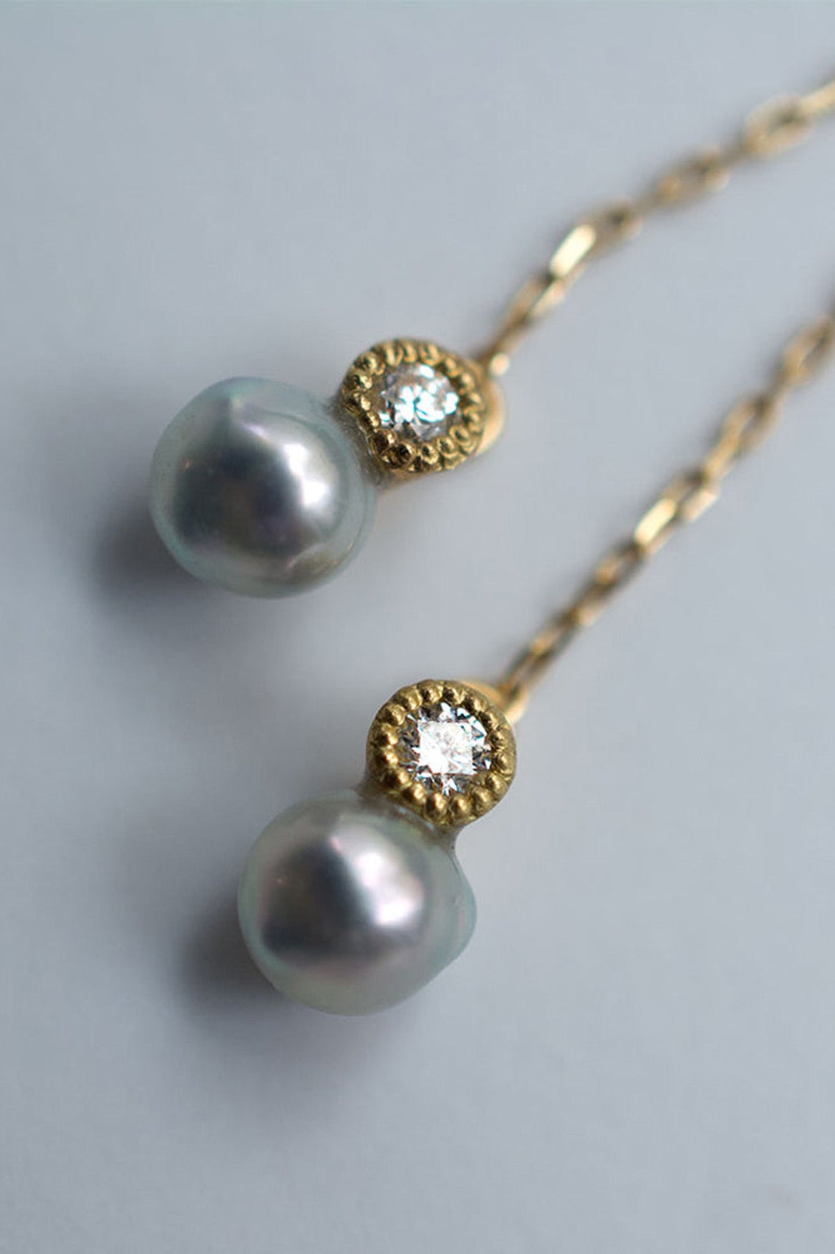 Close up of Baby Akoya Pearl Diamond Chain Earrings by Shinkai at Abacus Row Handmade Jewelry