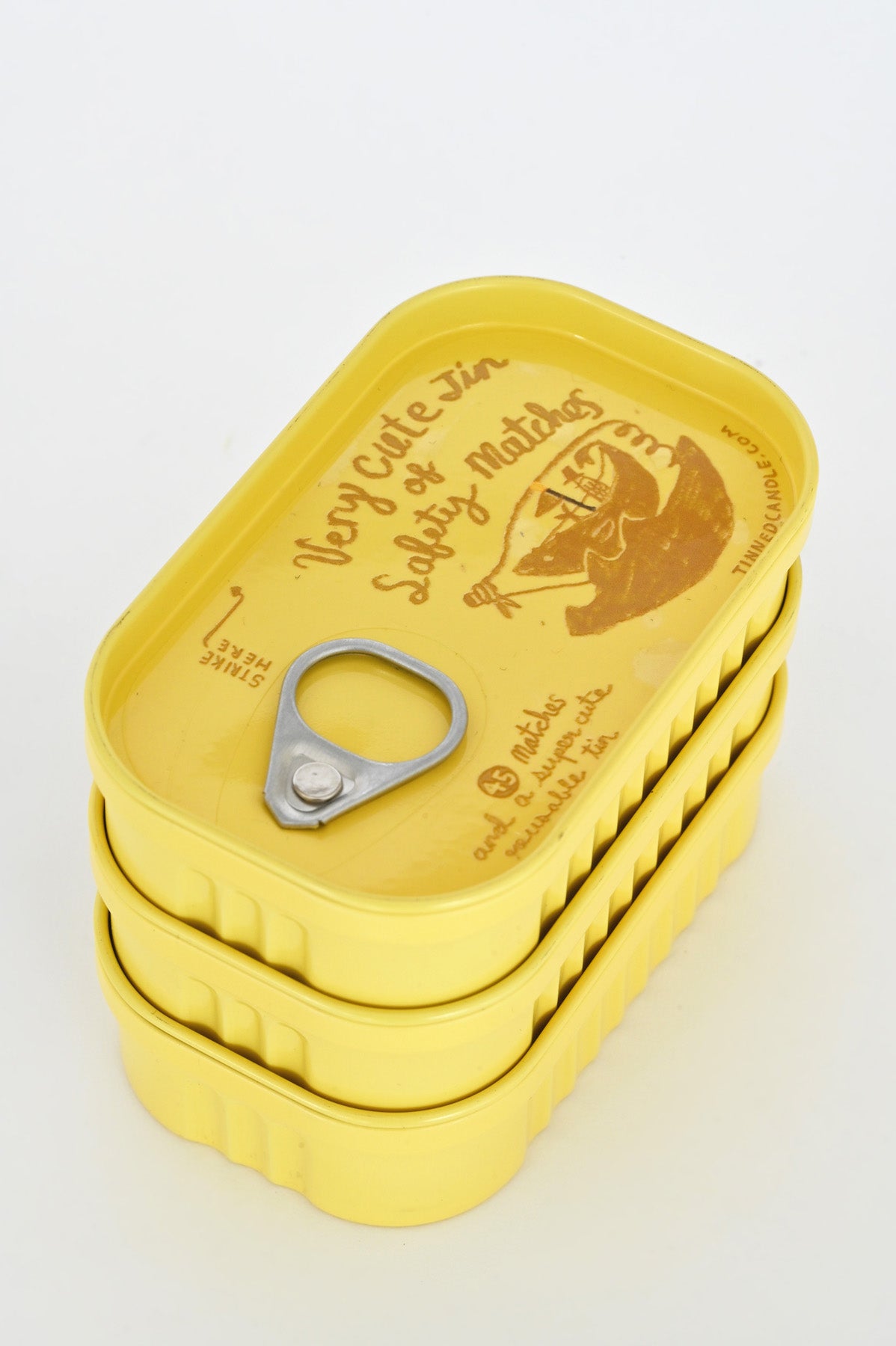 Yellow Tins of Safety Matches by Tinned Candle at Abacus Row
