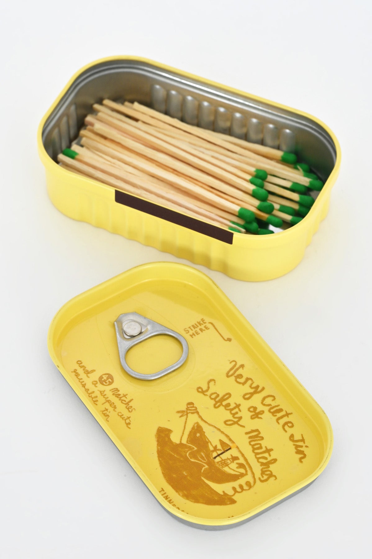 Open Yellow Tin of Safety Matches by Tinned Candle at Abacus Row