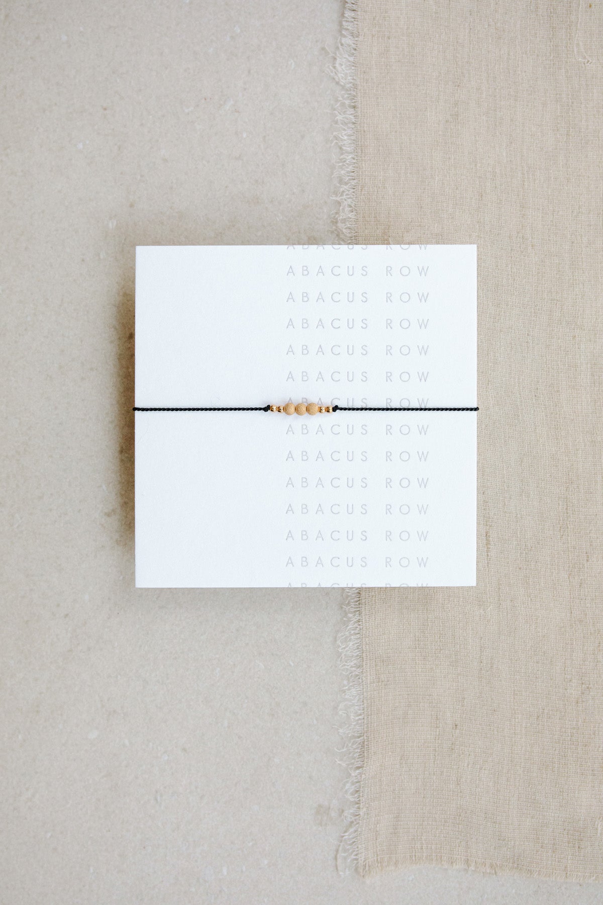 Black Friendship Bracelet No.1 on card from Abacus Row Handmade Jewelry