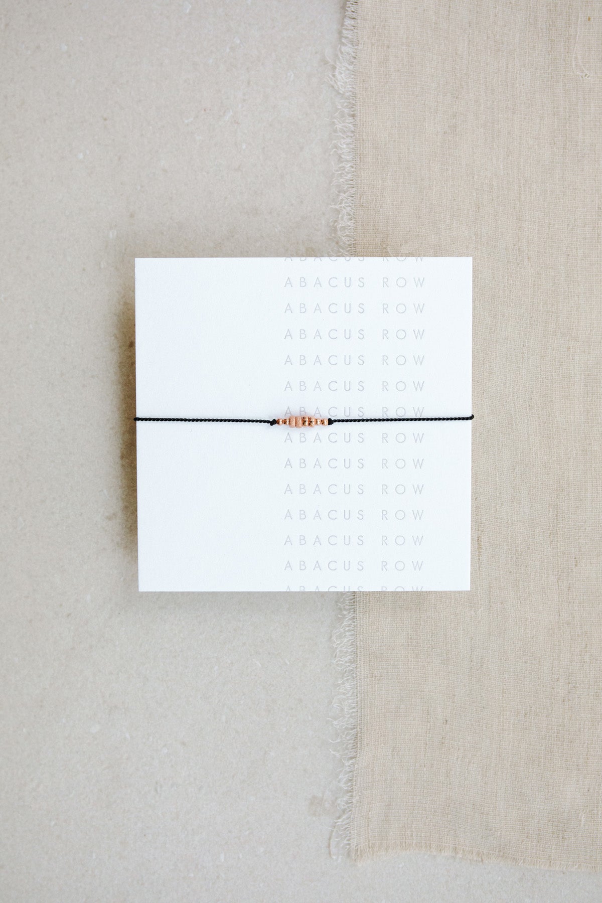 Black Friendship Bracelet No.5 on card from Abacus Row Handmade Jewelry