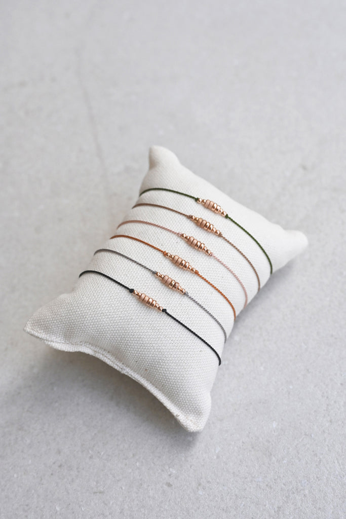 Friendship Bracelets No.5 on pillow from Abacus Row Handmade Jewelry