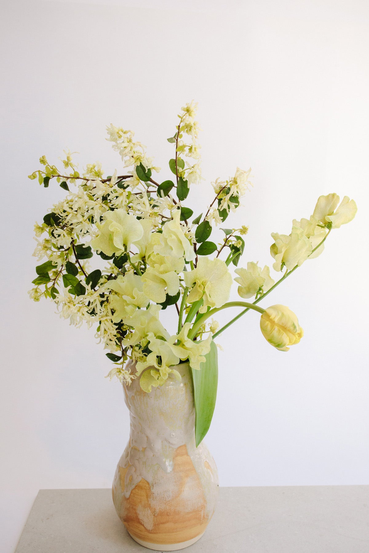 Silvercream Garlic Vase with flowers in it by Raina Lee at Abacus Row Handmade Jewelry