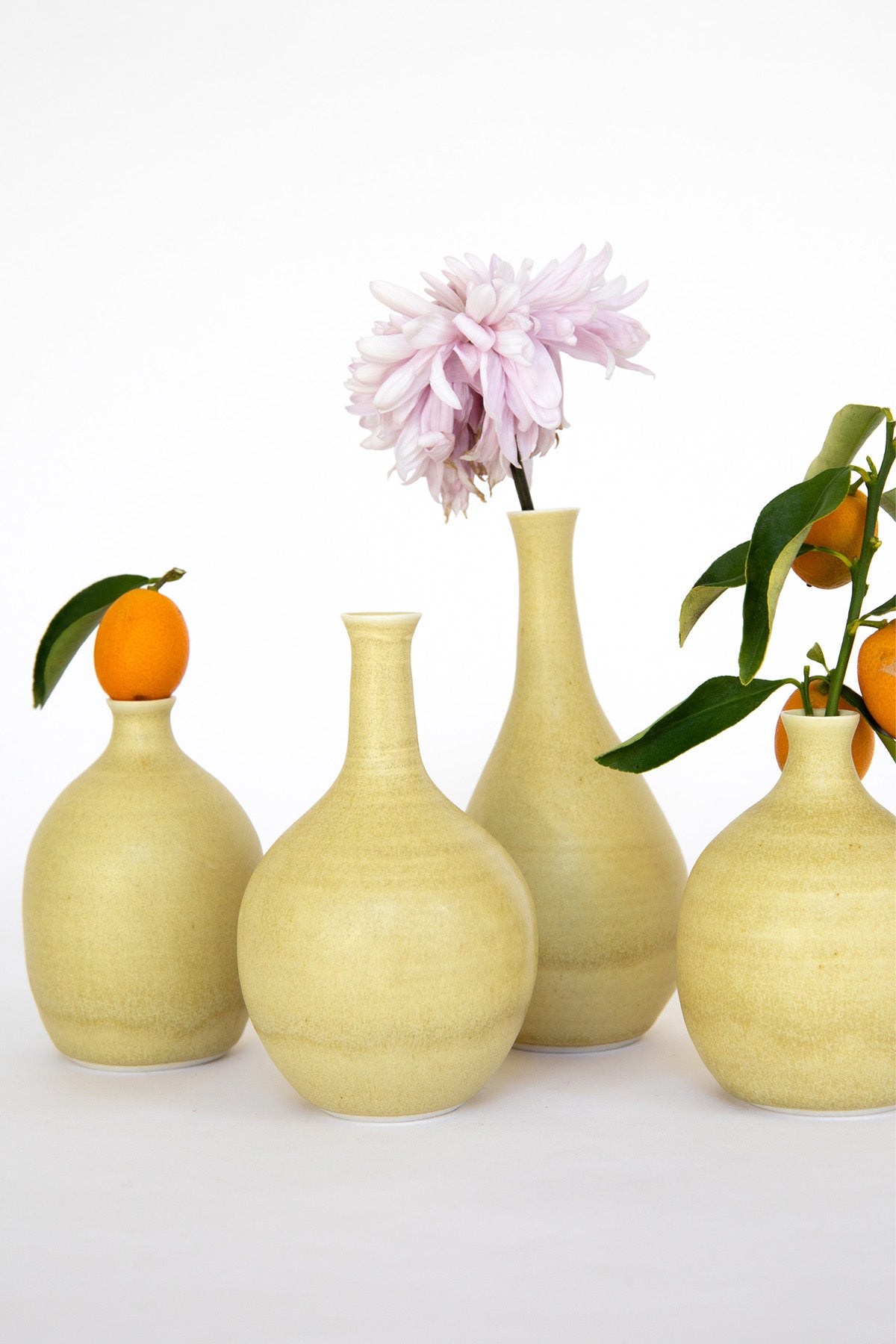Bud Vases by Vy Voi with flowers and fruit at Abacus Row